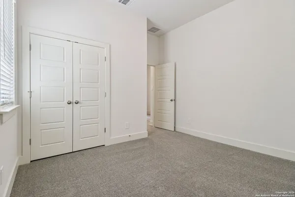 an empty room with white cabinet