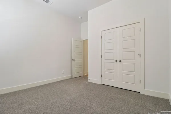 an empty room with closet area