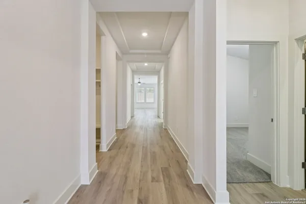 a view of a hallway with wooden floor