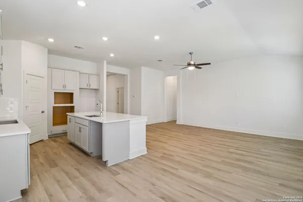 a view of kitchen with sink and cabinets