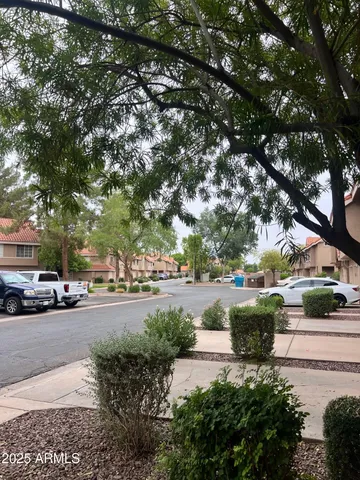 a view of a street with a cars parked