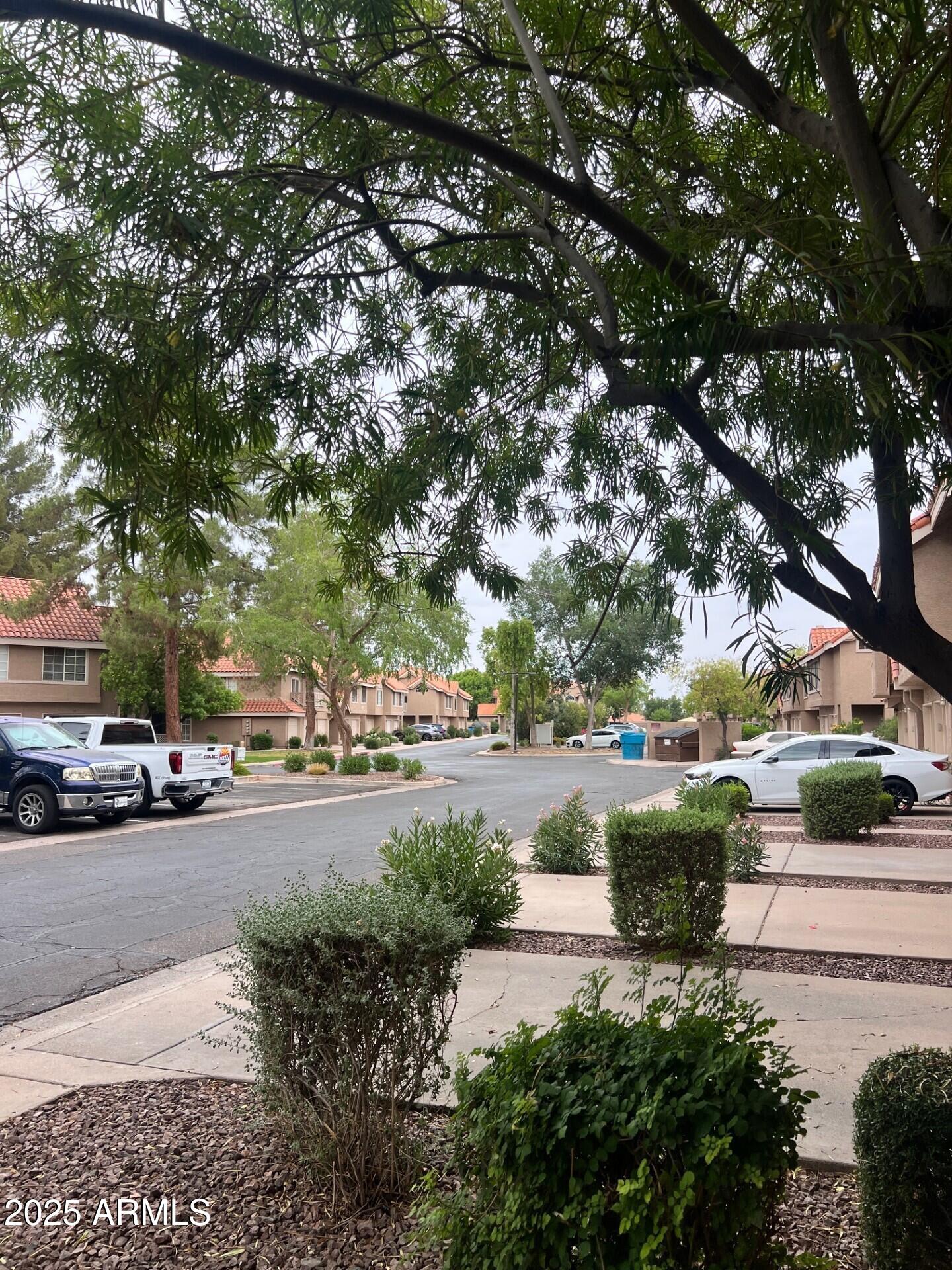 1633 East Lakeside Drive, Unit 17 Gilbert, AZ 85234 - Photo 16 of 19 a view of a street with a cars parked