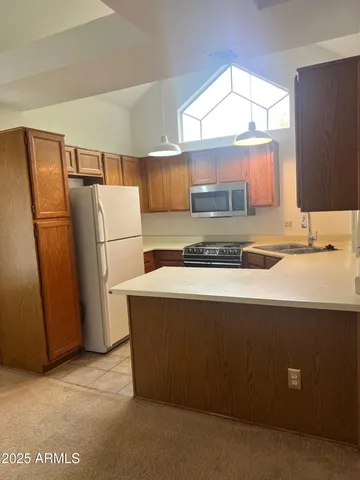 a kitchen with a refrigerator and a sink
