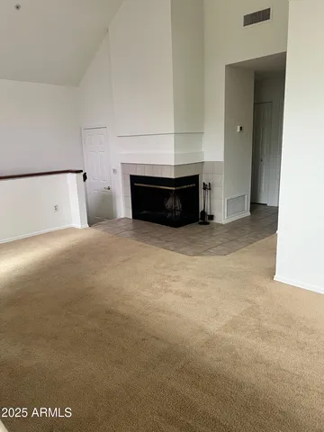 a view of empty room with fireplace