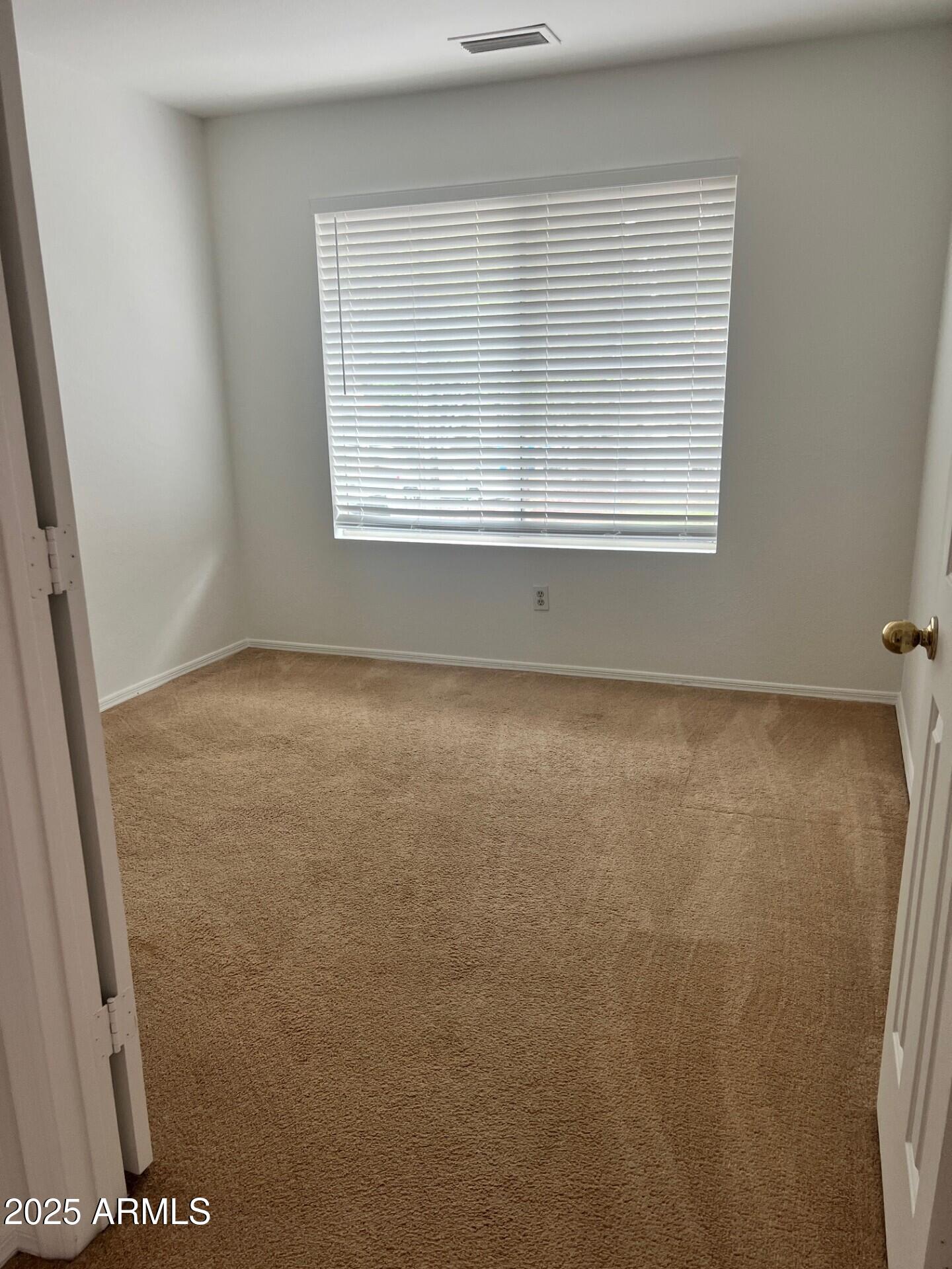 1633 East Lakeside Drive, Unit 17 Gilbert, AZ 85234 - Photo 8 of 19 an empty room with a window