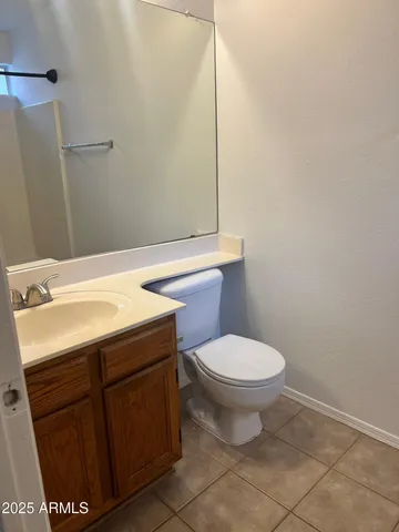 a bathroom with a sink toilet and mirror