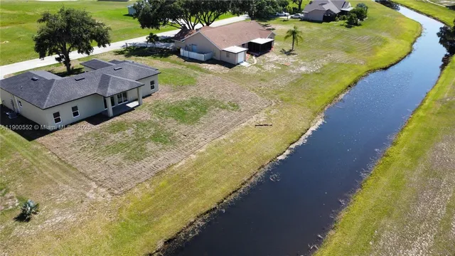 an aerial view of a house with a garden and swimming pool