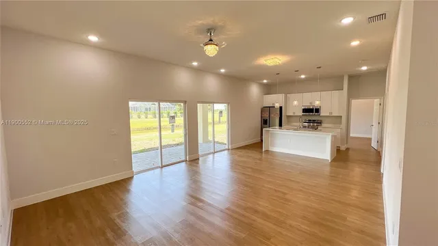a view of kitchen with cabinets and wooden floor