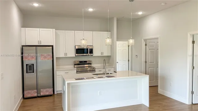 a kitchen with stainless steel appliances a refrigerator stove and microwave