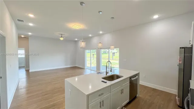 a kitchen with a sink and chandelier