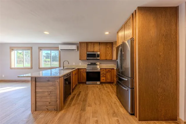 a kitchen with stainless steel appliances a refrigerator and a stove top oven