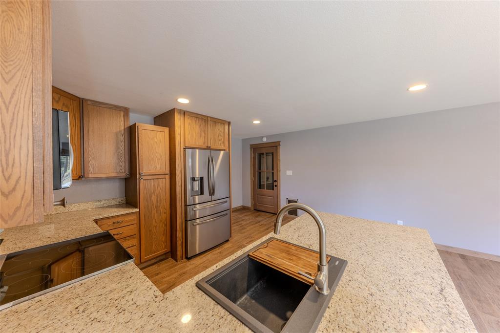 984 County Rd SE 4350 Scroggins, TX 75480 - Photo 17 of 35 a kitchen with stainless steel appliances granite countertop a refrigerator and a stove top oven