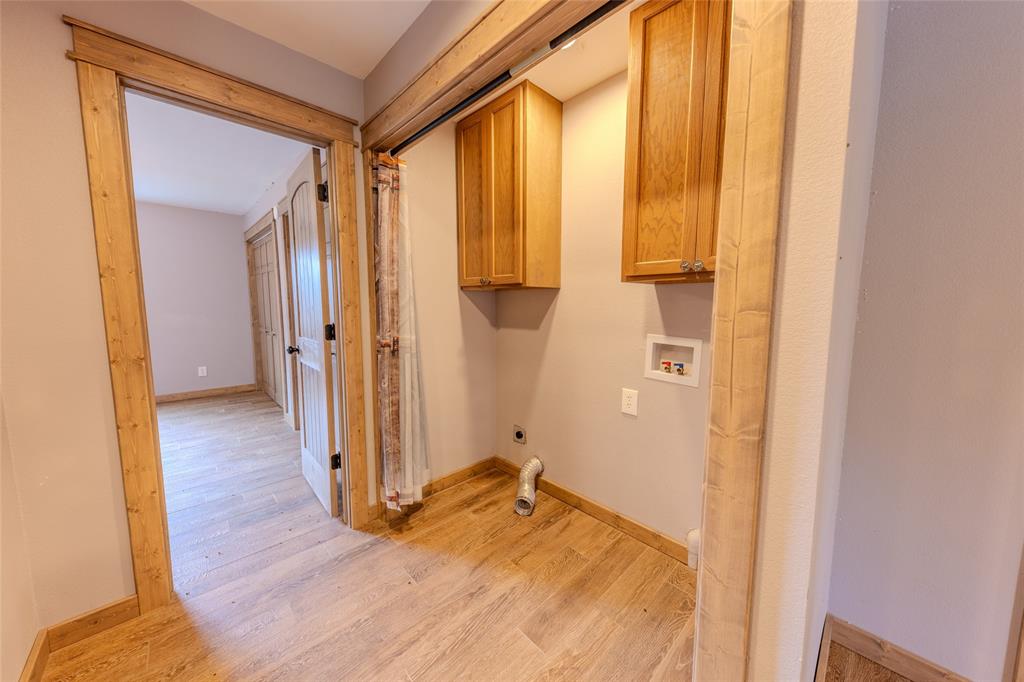 984 County Rd SE 4350 Scroggins, TX 75480 - Photo 19 of 35 wooden floor and chair in a room