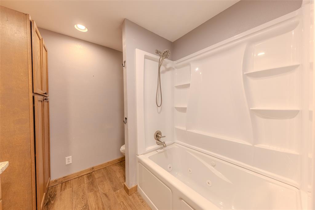 984 County Rd SE 4350 Scroggins, TX 75480 - Photo 26 of 35 a bathroom with a bathtub and a shower