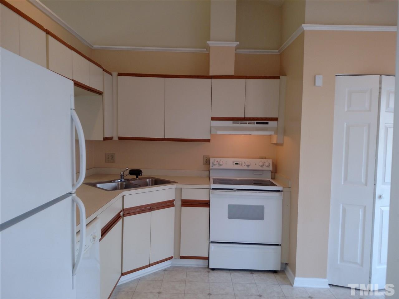 131 Renwick Court Raleigh, NC 27615 - Photo 3 of 21 a kitchen with white cabinets and white appliances