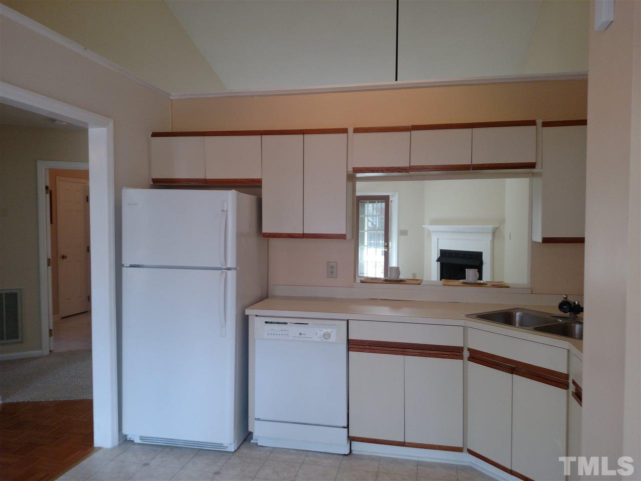 131 Renwick Court Raleigh, NC 27615 - Photo 6 of 21 a kitchen with cabinets and a refrigerator