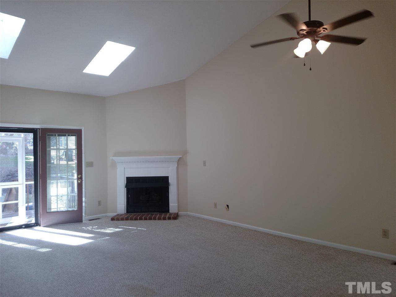131 Renwick Court Raleigh, NC 27615 - Photo 9 of 21 an empty room with windows and fireplace