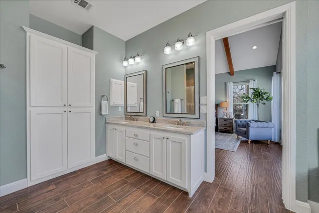 a spacious bathroom with a double vanity sink and a mirror