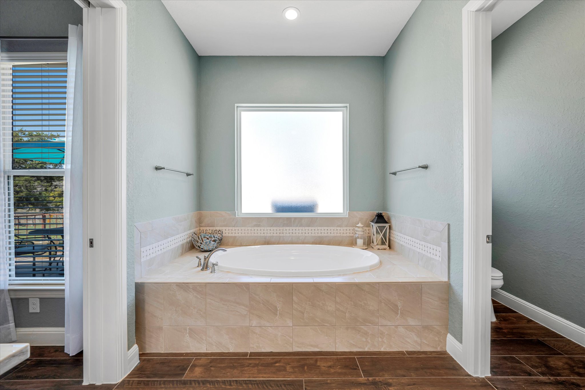 204 West Blanco Bend Drive Wimberley, TX 78676 - Photo 14 of 34 a bathroom with bathtub a shower a sink and a window