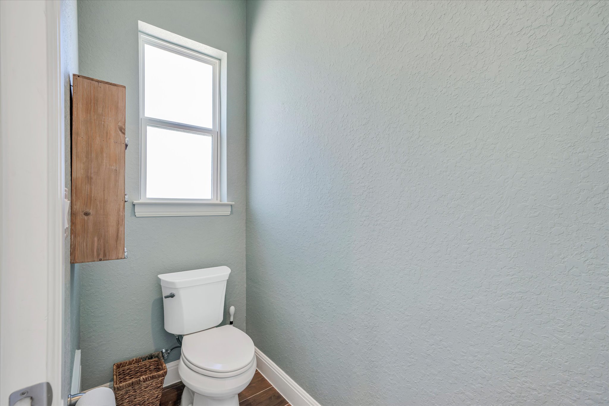 204 West Blanco Bend Drive Wimberley, TX 78676 - Photo 16 of 34 a white toilet sitting next to a window
