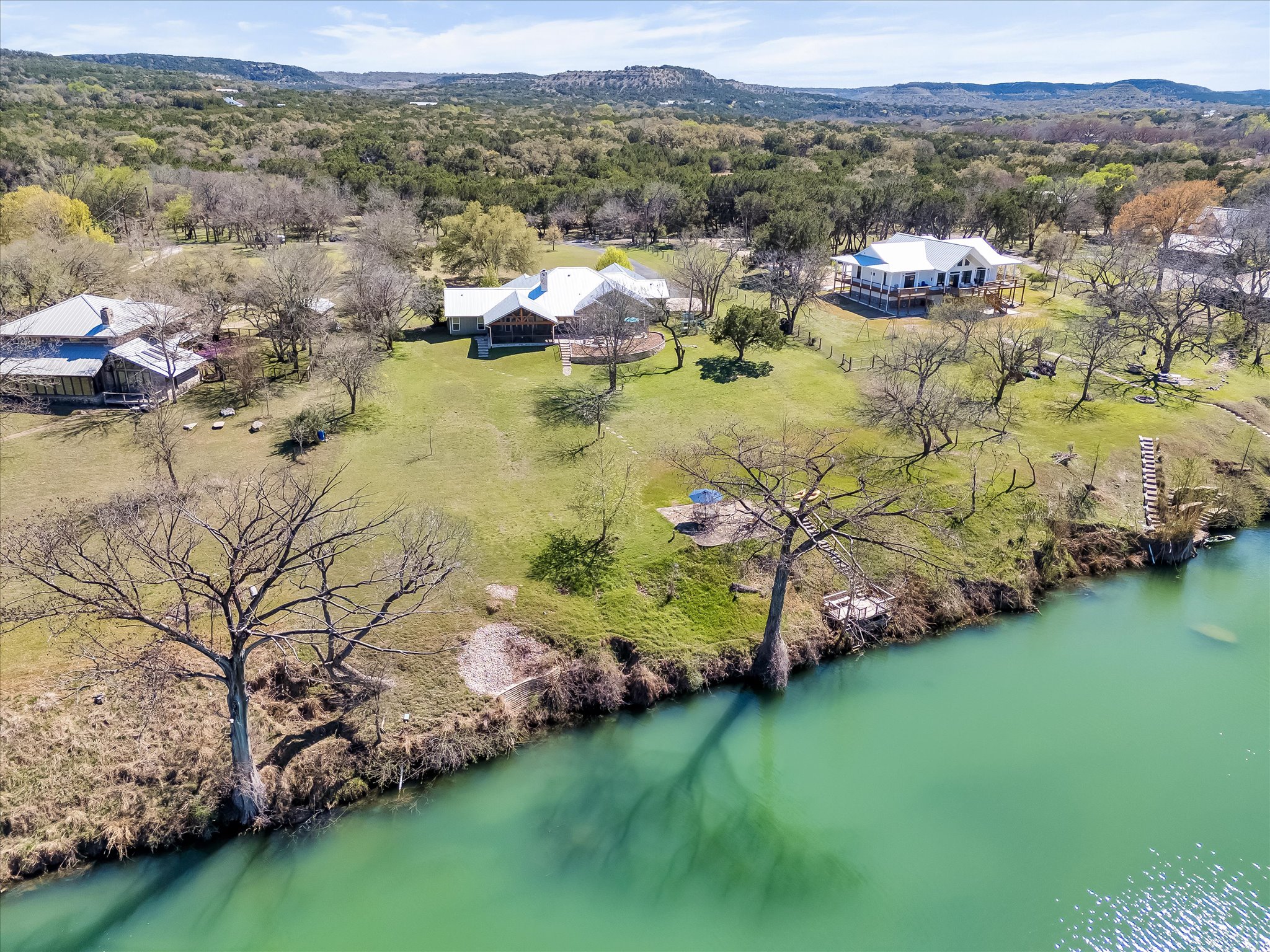 204 West Blanco Bend Drive Wimberley, TX 78676 - Photo 2 of 34 a view of a lake with houses