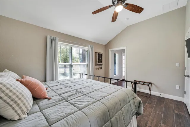 a bedroom with a large bed and a chandelier