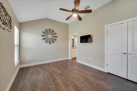 a bathroom with a granite countertop toilet sink and mirror