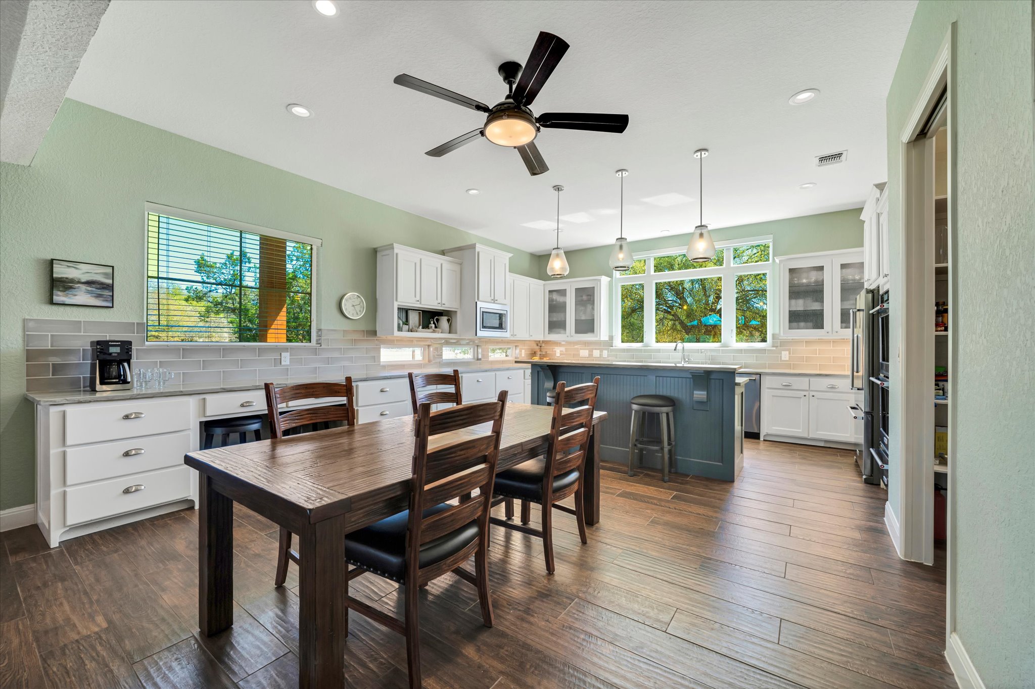 204 West Blanco Bend Drive Wimberley, TX 78676 - Photo 9 of 34 a kitchen with a table chairs appliances and cabinets