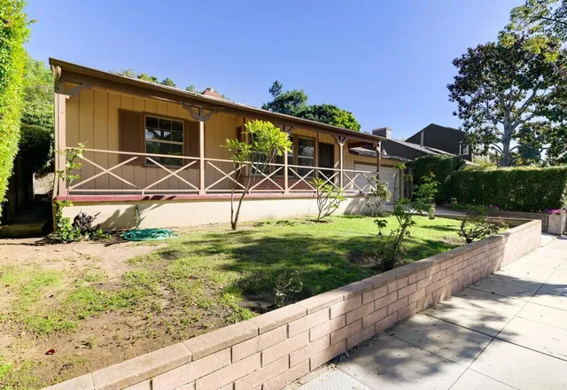 a backyard of a house with wooden fence