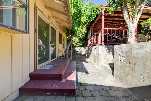 a wooden bench sitting in front of a building