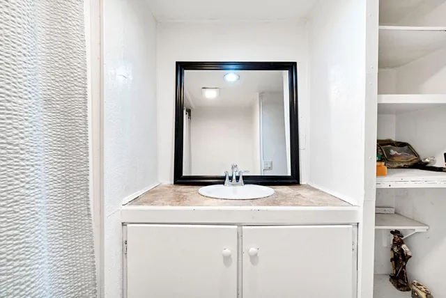 a bathroom with a sink and a mirror