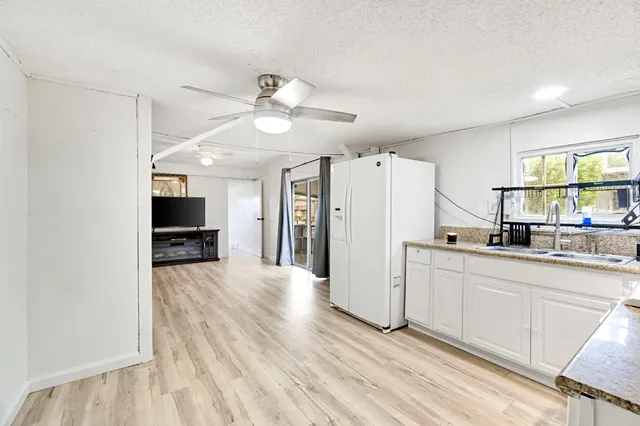 a kitchen with stainless steel appliances a refrigerator and a stove top oven
