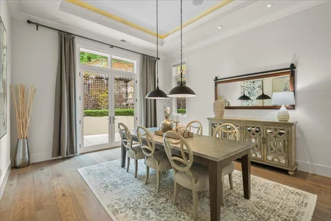 a dining room with furniture window and wooden floor