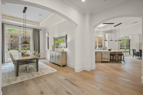 a living room with furniture a fireplace and a large window