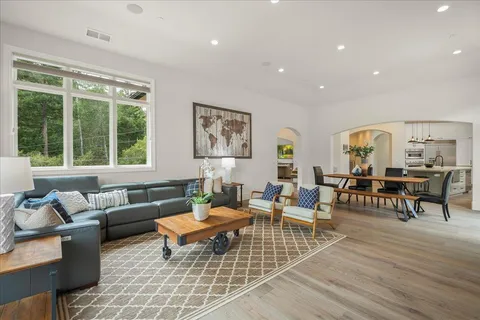 a kitchen with a sink a counter and chairs