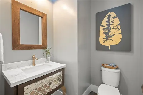 a view of a workspace with wooden floor and a window