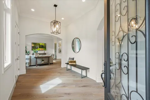 a living room with furniture a chandelier and a window