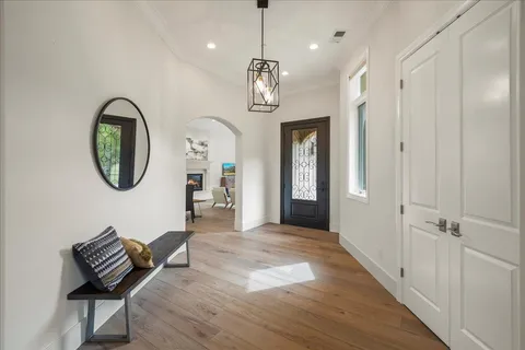 a living room with furniture and large windows