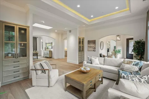a view of a hallway with wooden floor and windows