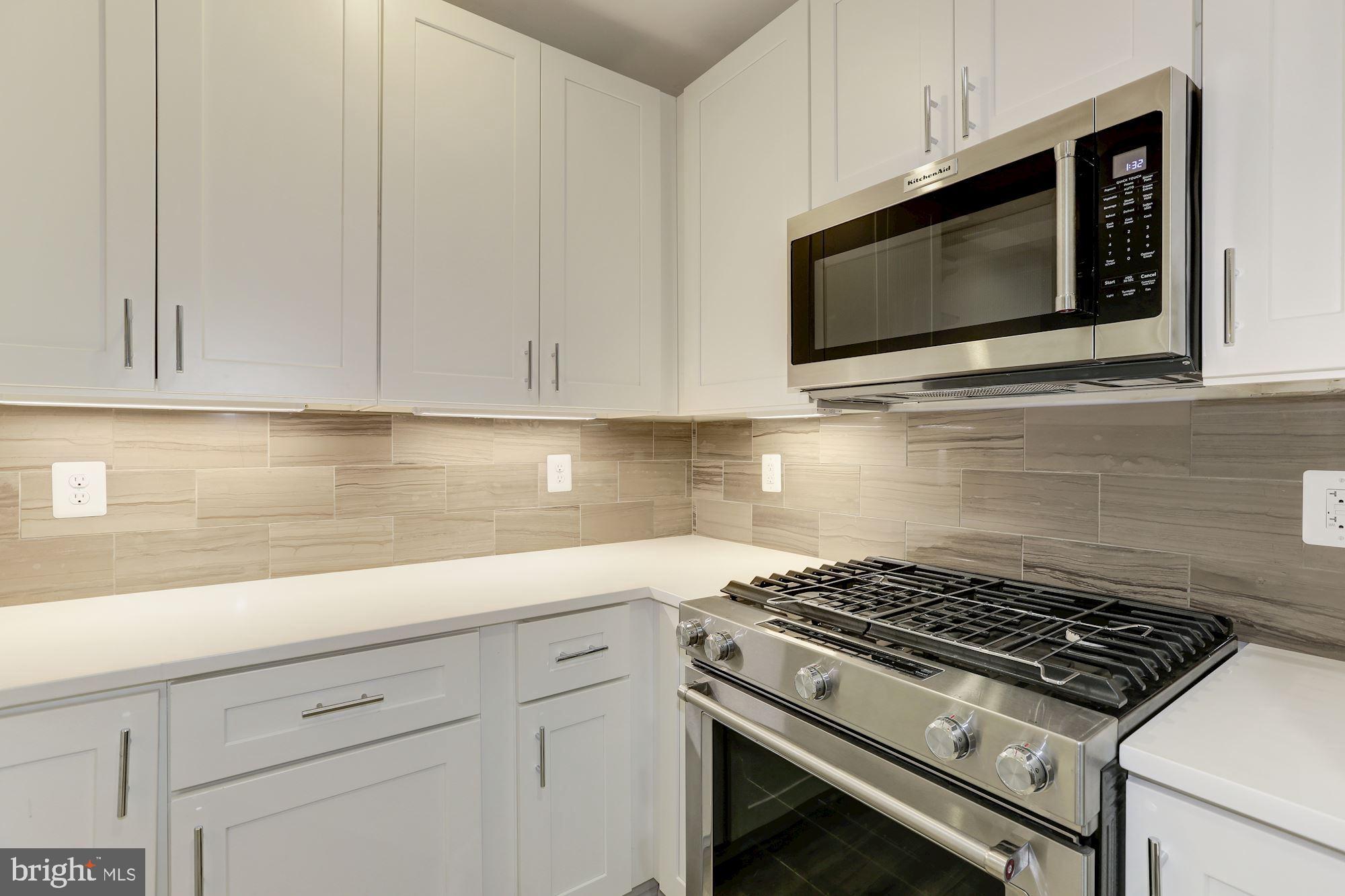 4008 Edmunds Street Northwest, Unit 6 Washington, DC 20007 - Photo 2 of 31 a kitchen with microwave cabinets and stove top oven
