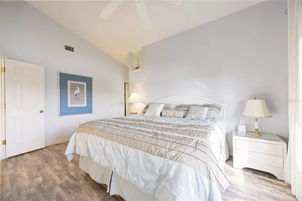 a bedroom with a bed and a chandelier