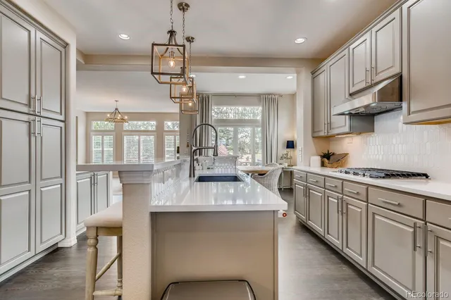 a kitchen with kitchen island granite countertop lots of counter top space and appliances