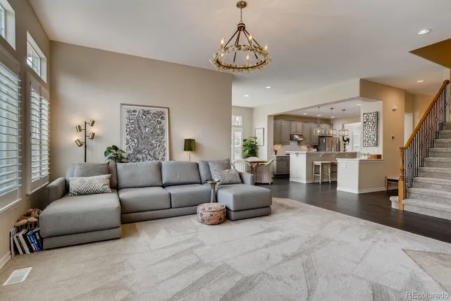 a living room with furniture and a chandelier