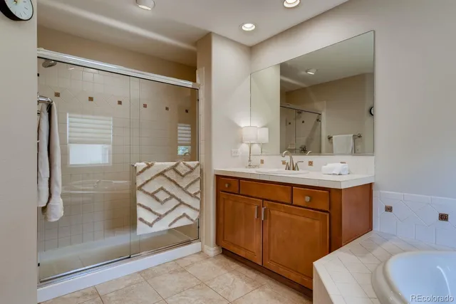 a bathroom with a sink a mirror and a shower