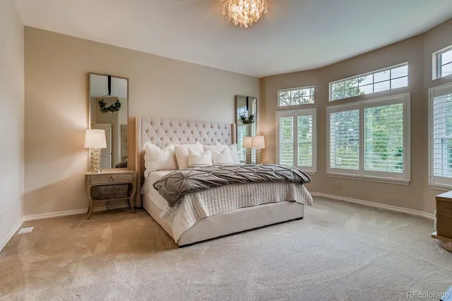 a spacious bedroom with a bed and a couch