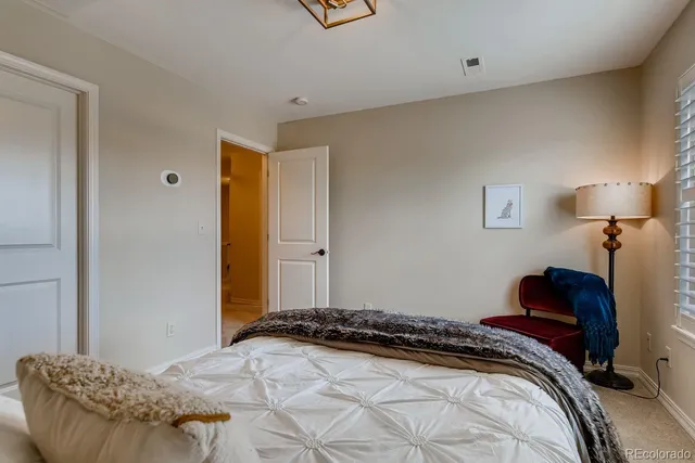 a bedroom with a bed and a couch