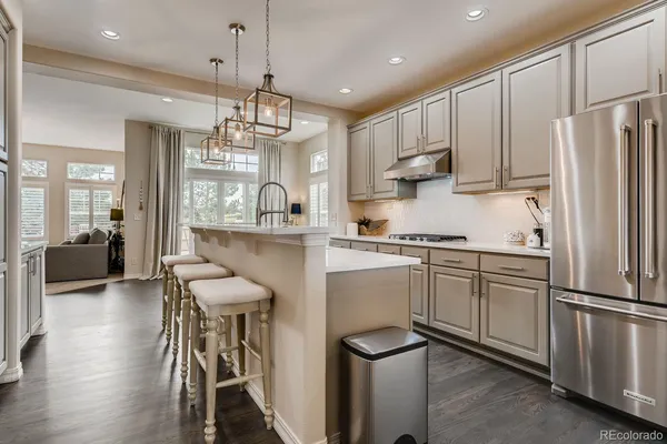 a living room with furniture a flat screen tv and a large window