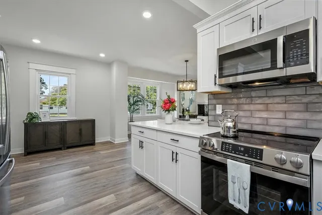a spacious bathroom with a granite countertop sink a mirror and a shower