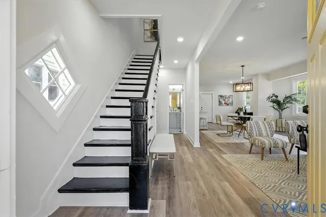 a view of entryway and hall with wooden floor
