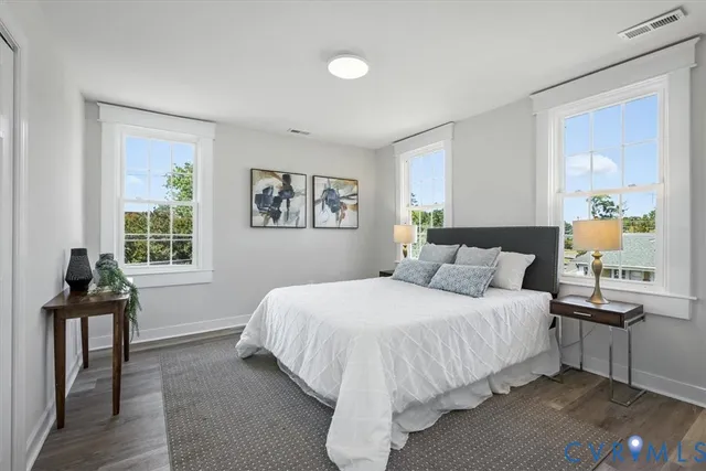 a view of hallway with stairs and wooden floor